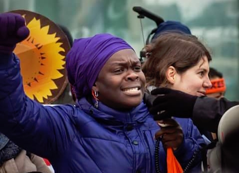 Sophie Dowllar Ogutu   speaking during a human rights march.